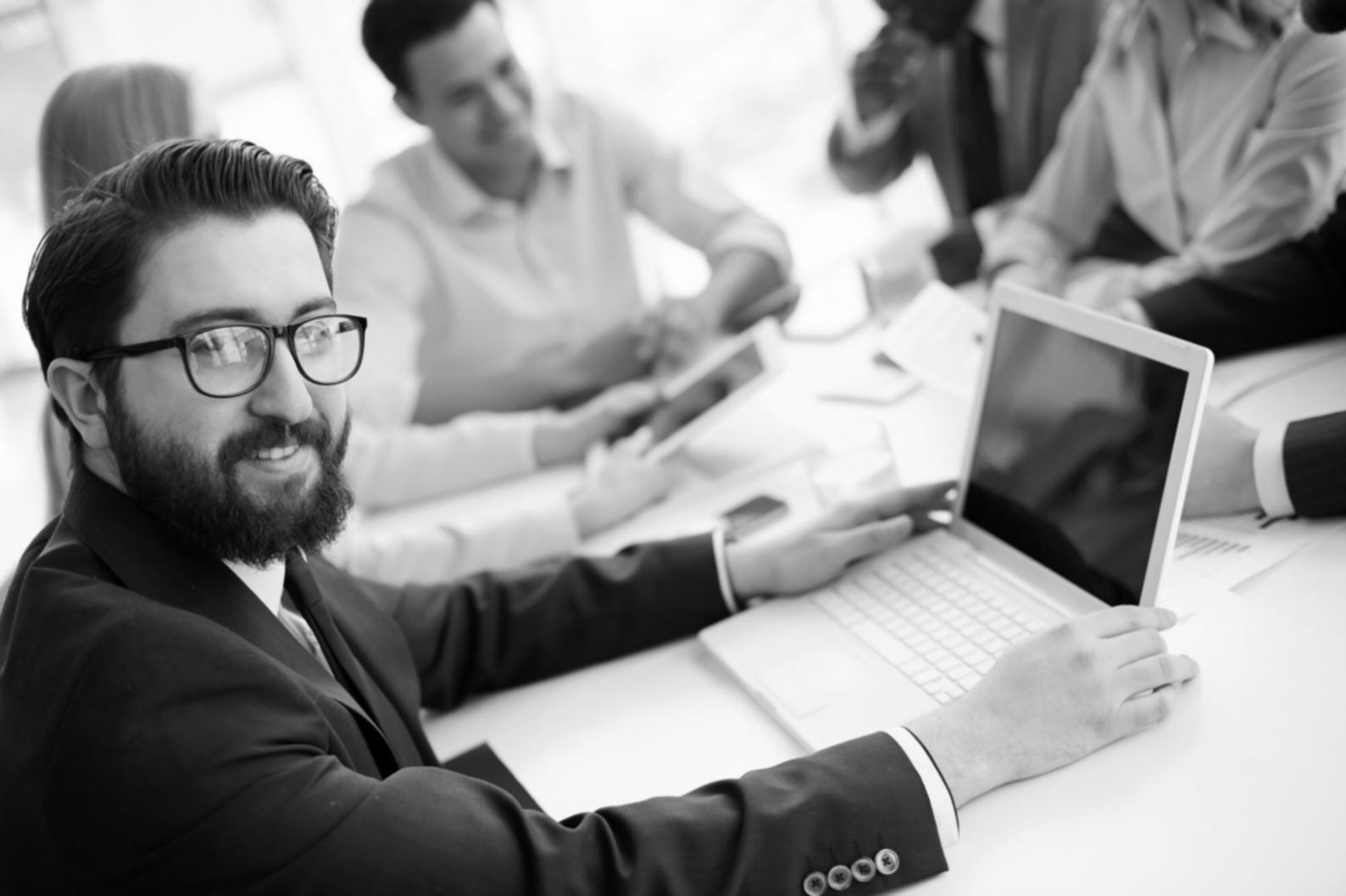 Business owner reviewing financial reports on laptop